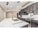 Bright kitchen featuring a large island with a sink, stainless steel appliances, and ample cabinet space at 18233 N 55Th Dr, Glendale, AZ 85308