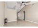 Open living room with tile flooring, neutral walls, and a view of the upper level and hallway at 18233 N 55Th Dr, Glendale, AZ 85308