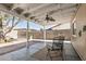 A comfortable covered patio featuring fan, seating, brick patio and shade at 18233 N 55Th Dr, Glendale, AZ 85308