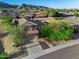 Aerial view of the property, showcasing front yard and neighborhood homes at sunset at 1834 W Nighthawk Way, Phoenix, AZ 85045