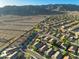 An aerial view showcases a meticulously planned community with manicured landscaping, mountain views, and residential streets at 1834 W Nighthawk Way, Phoenix, AZ 85045