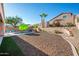 A serene backyard features a pool with a waterfall, desert landscaping, and privacy walls for ultimate relaxation at 1834 W Nighthawk Way, Phoenix, AZ 85045