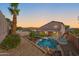 The backyard provides a private escape with a pool, rock features, and covered patio with comfortable seating at 1834 W Nighthawk Way, Phoenix, AZ 85045