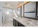 Bathroom featuring a double vanity with white marble countertops and dark cabinets at 1834 W Nighthawk Way, Phoenix, AZ 85045