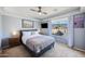 Comfortable bedroom features a ceiling fan, neutral paint, and large windows with beautiful views at 1834 W Nighthawk Way, Phoenix, AZ 85045