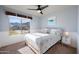 Inviting bedroom with ceiling fan, view from the window, and neutral carpet at 1834 W Nighthawk Way, Phoenix, AZ 85045