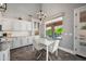 Bright dining area with a modern chandelier and a view of the sparkling pool at 1834 W Nighthawk Way, Phoenix, AZ 85045