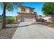 Two-story home featuring a stucco exterior, stone accents, and a long concrete driveway at 1834 W Nighthawk Way, Phoenix, AZ 85045