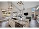 Modern kitchen island featuring granite countertops and stainless steel appliances overlooking a dining and living room at 1834 W Nighthawk Way, Phoenix, AZ 85045