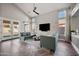 Bright living room showcasing wood floors, vaulted ceilings, neutral walls, with a modern design and access to the backyard at 1834 W Nighthawk Way, Phoenix, AZ 85045