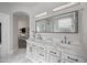 Bright primary bathroom with double sinks, marble countertops, and an archway leading to other bathroom areas at 1834 W Nighthawk Way, Phoenix, AZ 85045