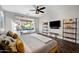 Bright main bedroom featuring hard wood floors, a window with a view, and a mounted television at 1834 W Nighthawk Way, Phoenix, AZ 85045
