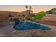 Backyard with a pool, rock waterfall, and lush landscaping at 1834 W Nighthawk Way, Phoenix, AZ 85045