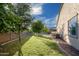 Well maintained lawn with a couple of trees and some shrubbery at 18544 W Devonshire Ave, Goodyear, AZ 85395
