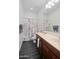 Clean bathroom featuring a double vanity sink, shower, and neutral decor at 18544 W Devonshire Ave, Goodyear, AZ 85395