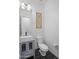 Stylish powder room with a modern vessel sink and elegant floral wall art at 18544 W Devonshire Ave, Goodyear, AZ 85395