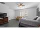 Comfortable bedroom featuring a ceiling fan, natural light, and ample space for relaxation at 18544 W Devonshire Ave, Goodyear, AZ 85395