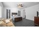Spacious bedroom with a cozy seating area, ceiling fan and natural light from the windows at 18544 W Devonshire Ave, Goodyear, AZ 85395