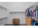Spacious walk-in closet with shelving and drawers for optimal organization and storage at 18544 W Devonshire Ave, Goodyear, AZ 85395