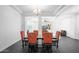 Formal dining area boasts a dark wood table and chairs, with an open view to other living spaces at 18544 W Devonshire Ave, Goodyear, AZ 85395