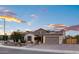 Charming, single-story home with a stone accent, two-car garage, solar panels, and desert landscaping at 18544 W Devonshire Ave, Goodyear, AZ 85395