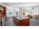 Open concept kitchen featuring an island, granite countertops, stainless steel appliances, and seamless flow to the living area at 18544 W Devonshire Ave, Goodyear, AZ 85395