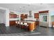 Gourmet kitchen with granite countertops, stainless steel appliances, and a large island with seating at 18544 W Devonshire Ave, Goodyear, AZ 85395