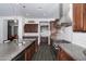 Beautiful kitchen with a central island, stainless steel hood, and sleek tile backsplash at 18544 W Devonshire Ave, Goodyear, AZ 85395