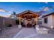 Beautiful outdoor living area with fireplace, comfortable seating, grill, and fire pit at dusk at 18544 W Devonshire Ave, Goodyear, AZ 85395