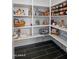 Organized walk-in pantry offering plenty of shelving and storage for food and kitchen essentials at 18544 W Devonshire Ave, Goodyear, AZ 85395