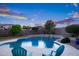 A spacious backyard pool with two chairs, perfect for enjoying warm weather and relaxation at 18544 W Devonshire Ave, Goodyear, AZ 85395