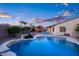 Beautiful backyard pool with a covered patio and outdoor seating, creating an inviting outdoor space at 18544 W Devonshire Ave, Goodyear, AZ 85395