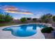 Large pool with patio; landscaping features surrounding the pool enhance its beauty and the outdoor space at 18544 W Devonshire Ave, Goodyear, AZ 85395