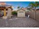 Backyard shed with stone accents and gravel landscaping, providing a functional outdoor storage solution at 18544 W Devonshire Ave, Goodyear, AZ 85395