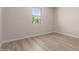 Minimalist bedroom with wood floors, white walls, and one window at 18773 E Panchito Dr, Gold Canyon, AZ 85118