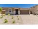 Charming single-story home with desert landscaping and a brick driveway at 18773 E Panchito Dr, Gold Canyon, AZ 85118