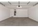 Spacious two car garage with white walls and ceiling and finished concrete floors at 18773 E Panchito Dr, Gold Canyon, AZ 85118