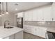 Bright kitchen featuring white cabinets, stainless steel appliances, and grey backsplash at 18773 E Panchito Dr, Gold Canyon, AZ 85118