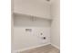Bright laundry room with a shelf and hookups for appliances at 18773 E Panchito Dr, Gold Canyon, AZ 85118
