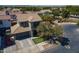 Beautiful home with lush green grass, desert landscaping, and a large driveway with a three-car garage at 18811 E Pelican Ct, Queen Creek, AZ 85142
