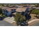 Aerial shot of a home with a well-manicured lawn, desert landscaping, and red-tiled roofs in a vibrant community at 18811 E Pelican Ct, Queen Creek, AZ 85142