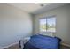 Comfortable bedroom featuring plush carpet, a bright window, and neutral paint at 18811 E Pelican Ct, Queen Creek, AZ 85142