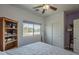 Bright bedroom with a window view, closet, and additional wooden shelving for ample storage at 18811 E Pelican Ct, Queen Creek, AZ 85142