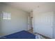 Bedroom featuring carpet floors, a bright window, neutral walls, and closet doors at 18811 E Pelican Ct, Queen Creek, AZ 85142