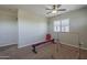 Bright bonus room featuring a ceiling fan, carpet floors, and gymnastics equipment at 18811 E Pelican Ct, Queen Creek, AZ 85142