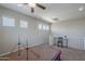 Open bonus room featuring a ceiling fan, a small desk, and gymnastics equipment at 18811 E Pelican Ct, Queen Creek, AZ 85142