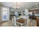 Open-concept dining room featuring an elegant chandelier, hardwood floors, and a seamless transition to the living area at 18811 E Pelican Ct, Queen Creek, AZ 85142
