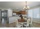 Charming dining area featuring a chandelier and table with chairs and adjacent kitchen at 18811 E Pelican Ct, Queen Creek, AZ 85142