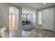 Inviting entryway with neutral tones, decorative tile flooring, and an adjacent carpeted sitting room at 18811 E Pelican Ct, Queen Creek, AZ 85142