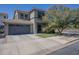 Two-story home featuring a two-car garage, a well-manicured lawn, and mature landscaping at 18811 E Pelican Ct, Queen Creek, AZ 85142